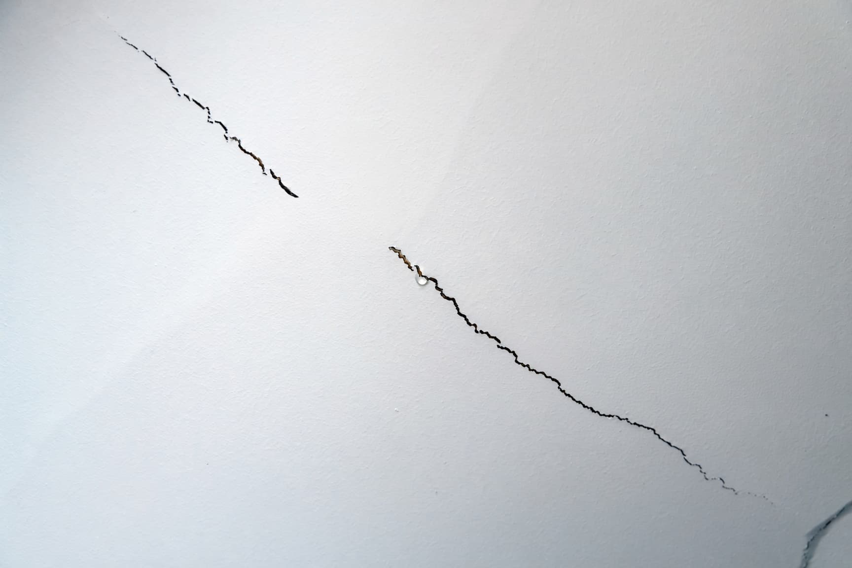 Long crack running along a drywall ceiling seam in a San Diego home