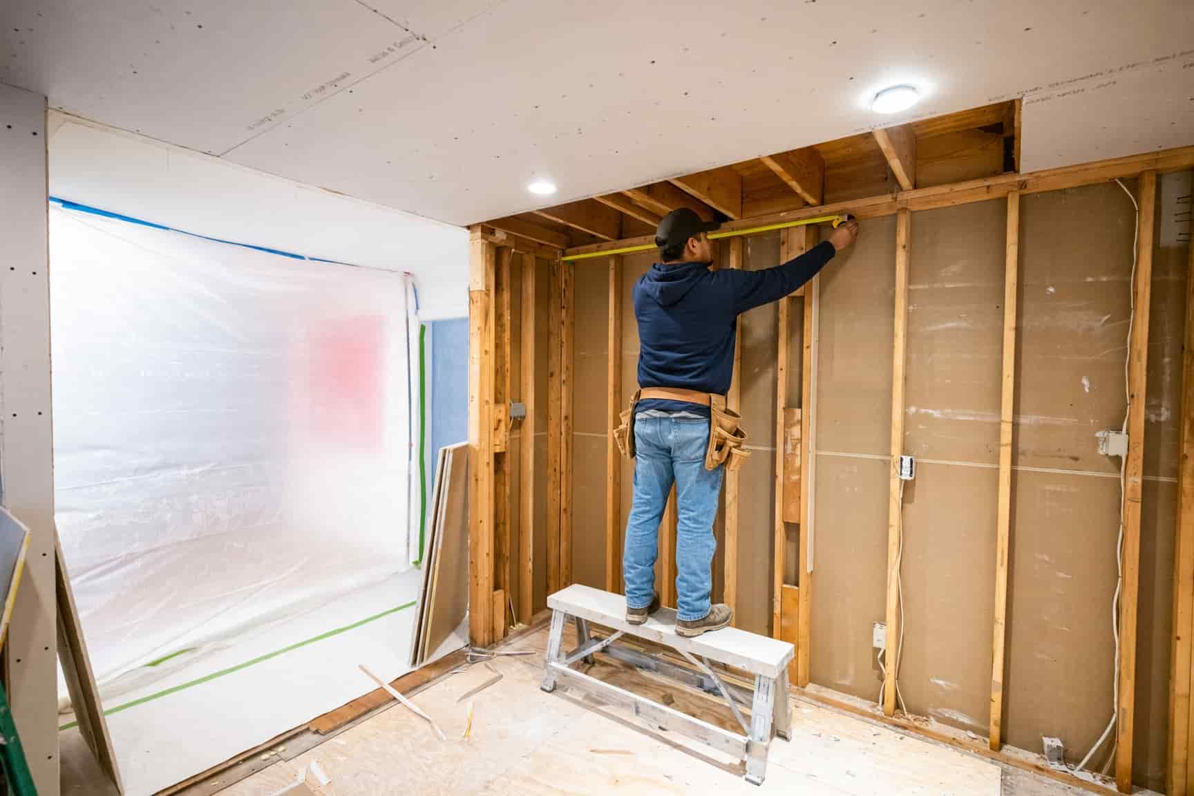 New drywall ceiling being installed in a San Diego home after tear-out