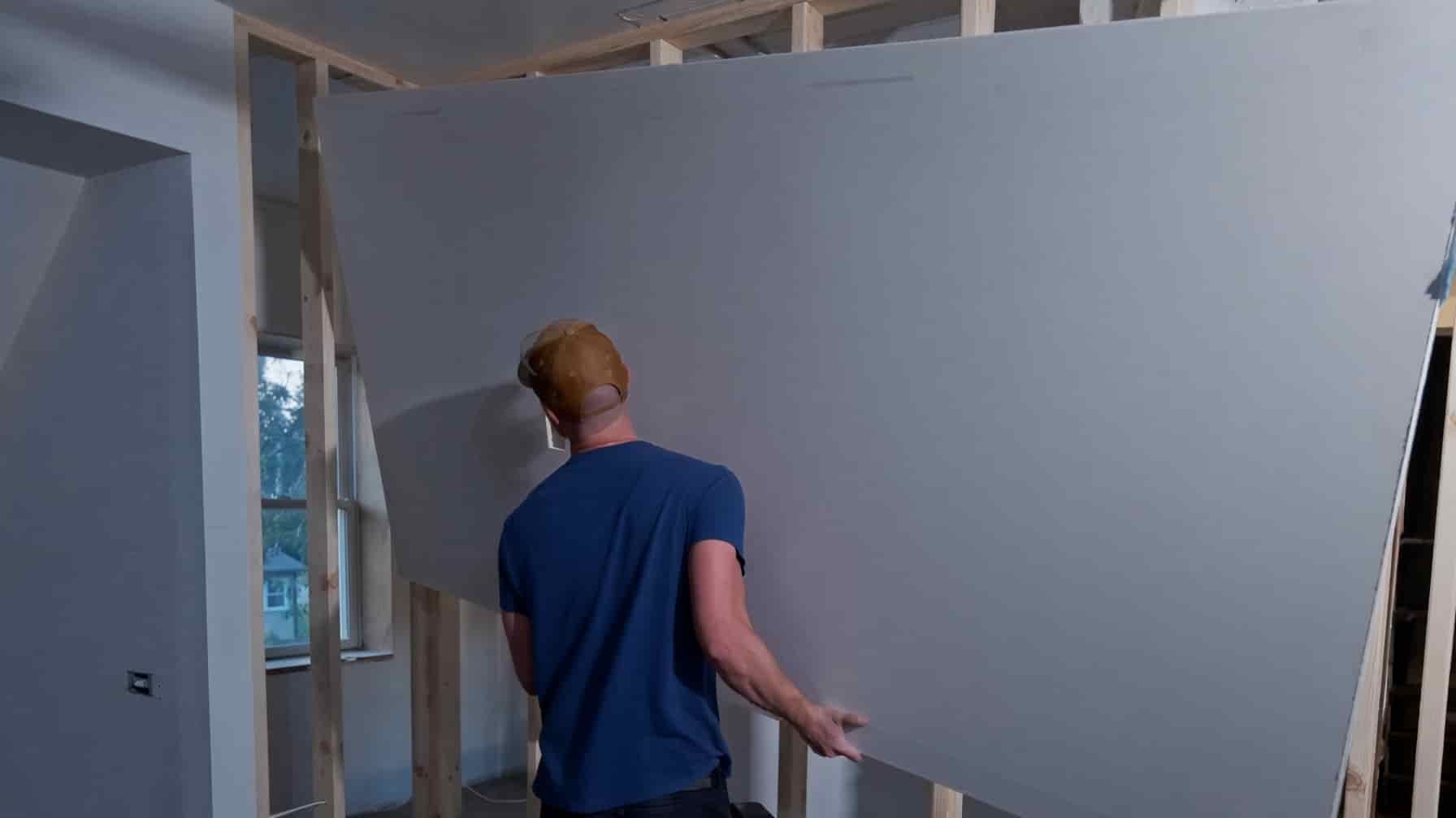 Drywall sheets stocked and being hung in a San Diego project