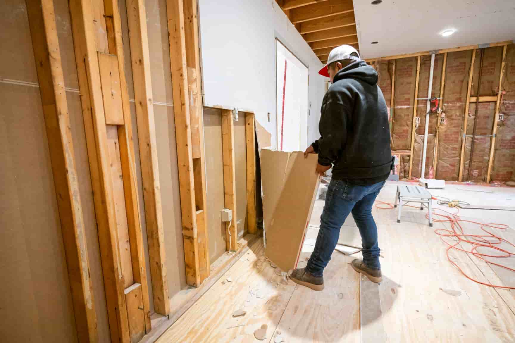 Drywall removed down to clean exposed framing during a tear-out in a San Diego home