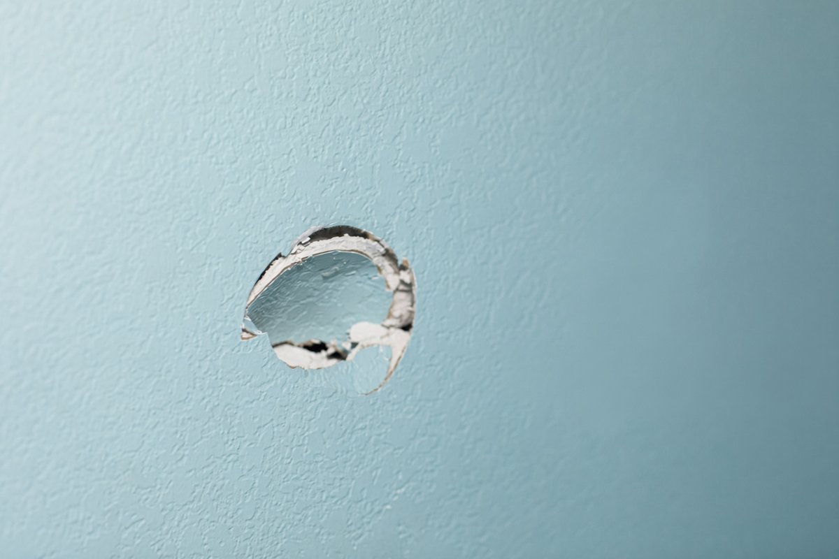 About to repair a doorknob hole in a San Diego home's drywall