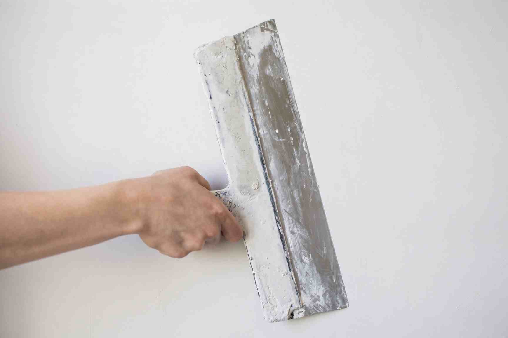 Skim coating textured walls to a smooth finish in San Diego