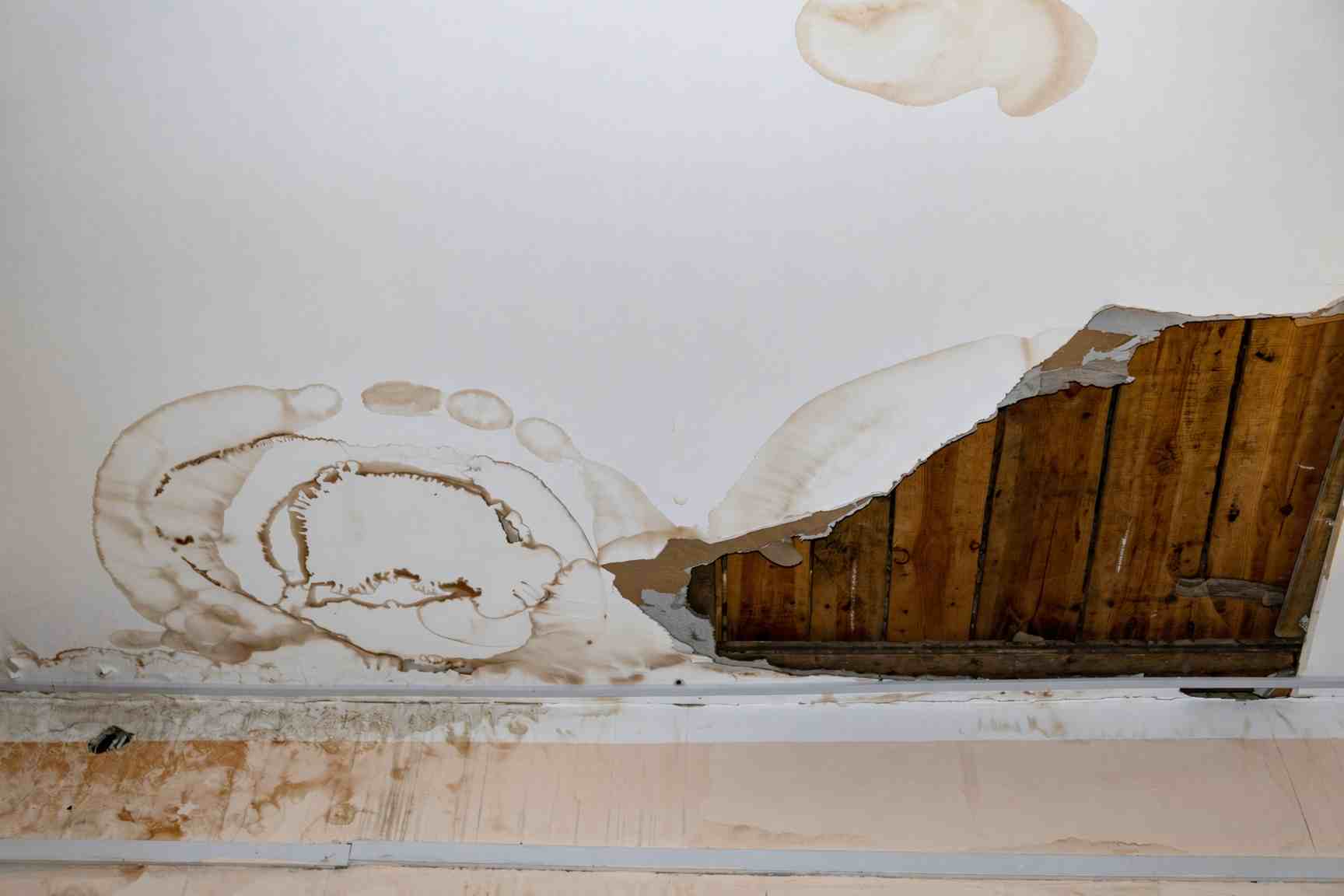 Water damaged drywall about to be cut out and replaced in a San Diego home
